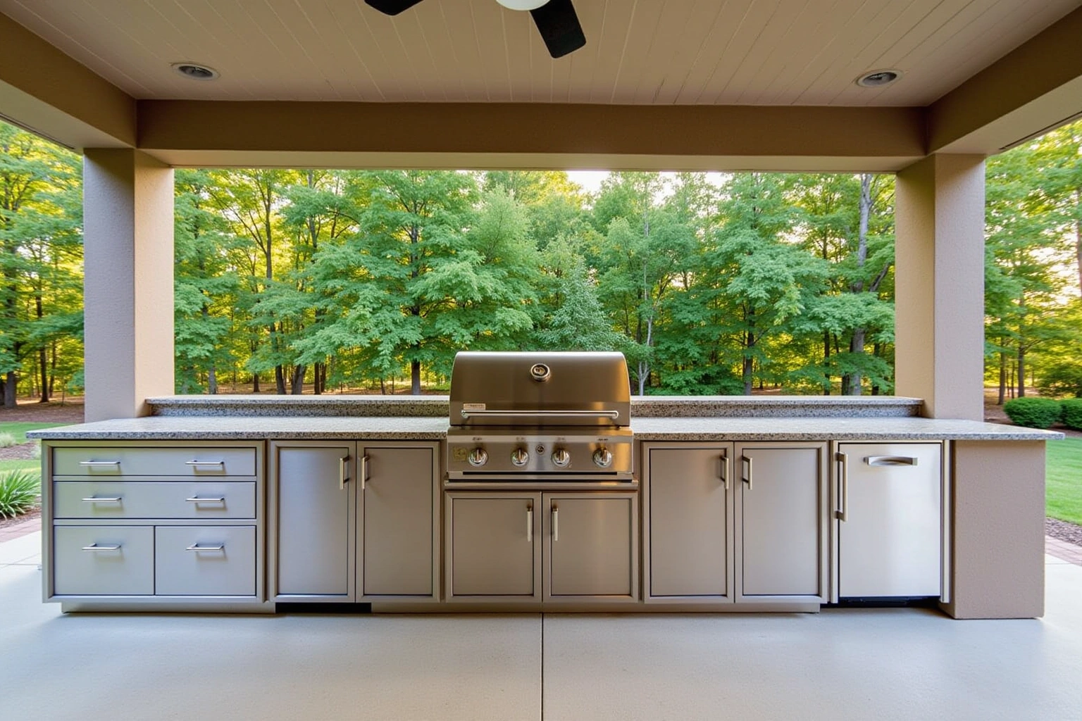 Covered patio outdoor kitchen with a run of stainless steel cabinet doors and drawers under granite, one built-in grill.